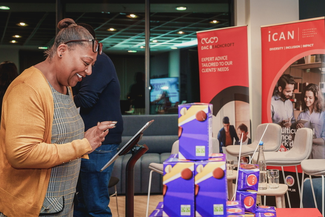 An attendee leaving spoken feedback on the SaySo kiosk at an iCAN event